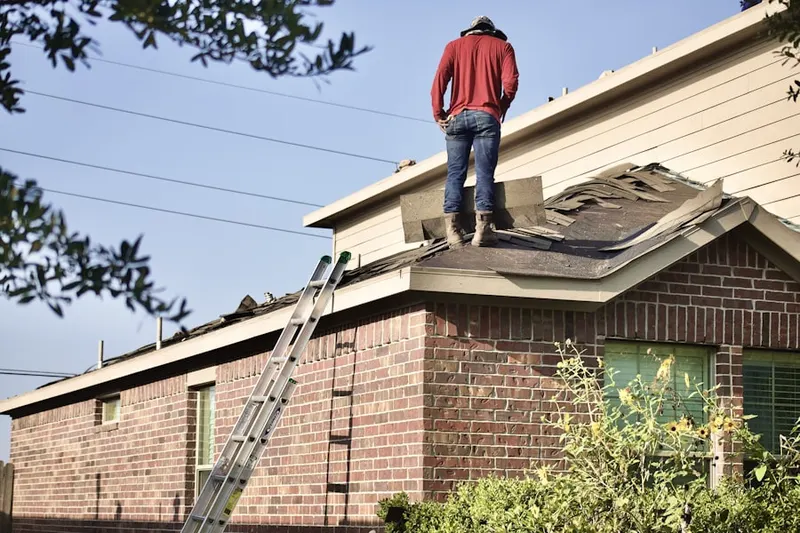 Professional roofer working on a residential roof in Polaris South